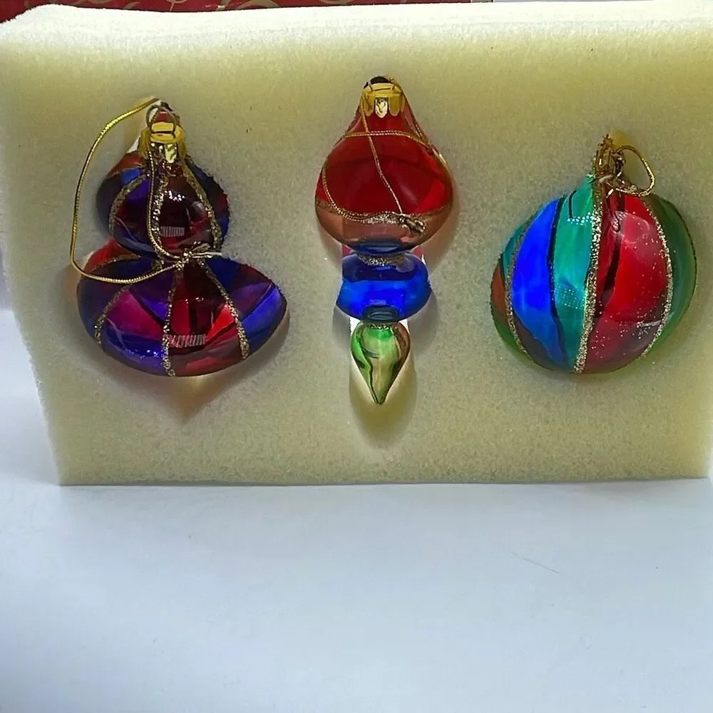 Vintage Avon 2001 Holiday Treasures blown glass ornaments.